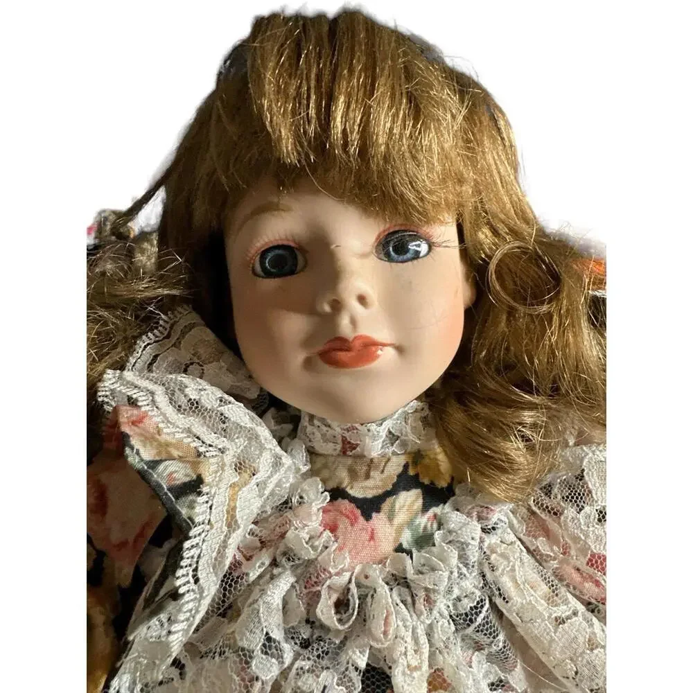 18” porcelain doll with flower dress and brown hair